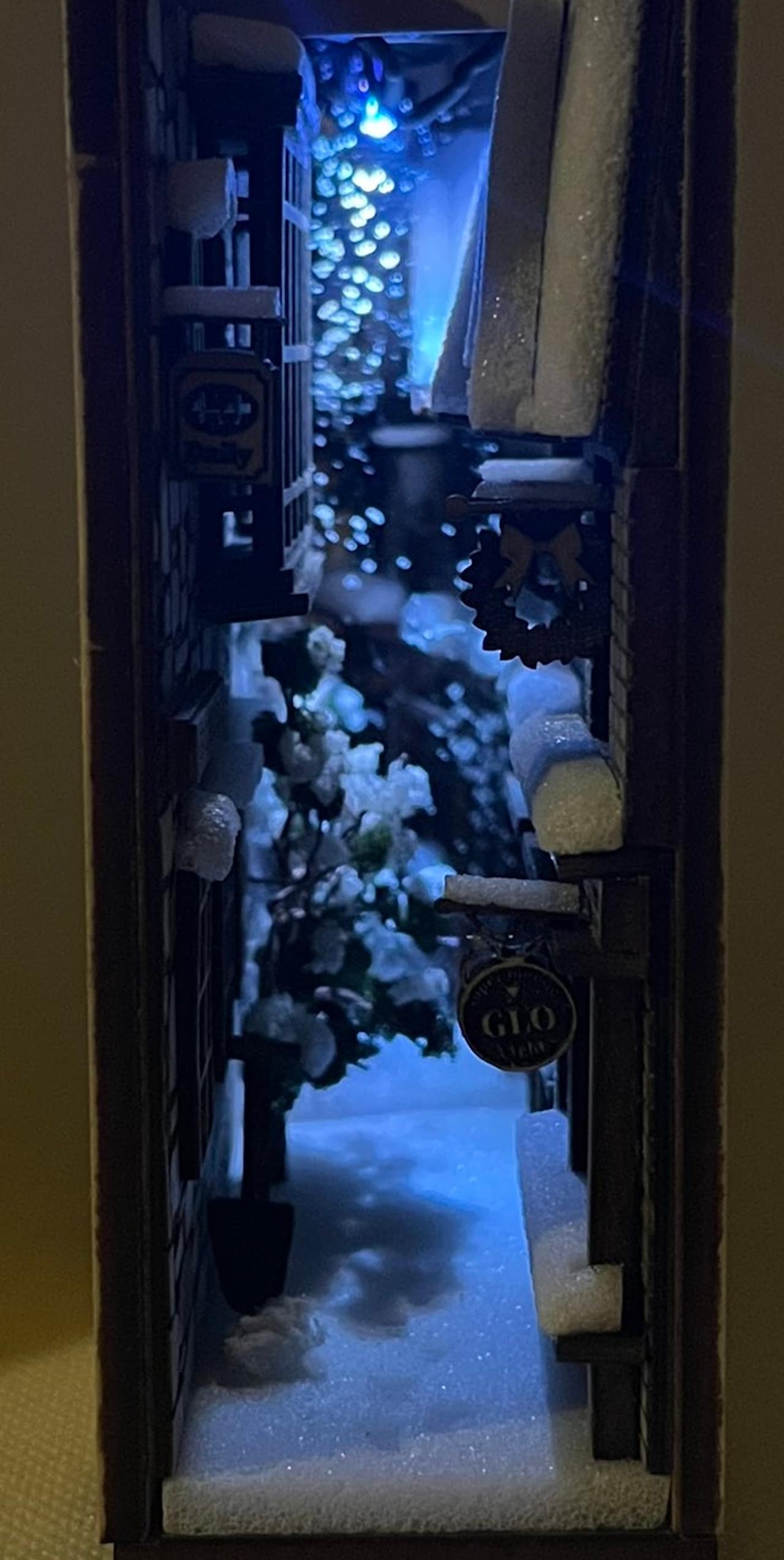 Picture of a book nook showing a winter scene of a Japanese alley in winter with blue light in the background.