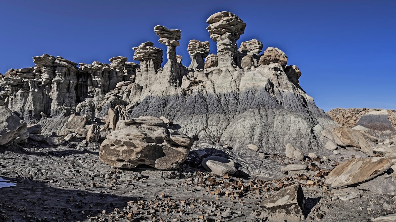 Picture of gray and white Hoodoos which are spire-like rock formations in Devils' playground in Petrified Forest National Park Arizona.