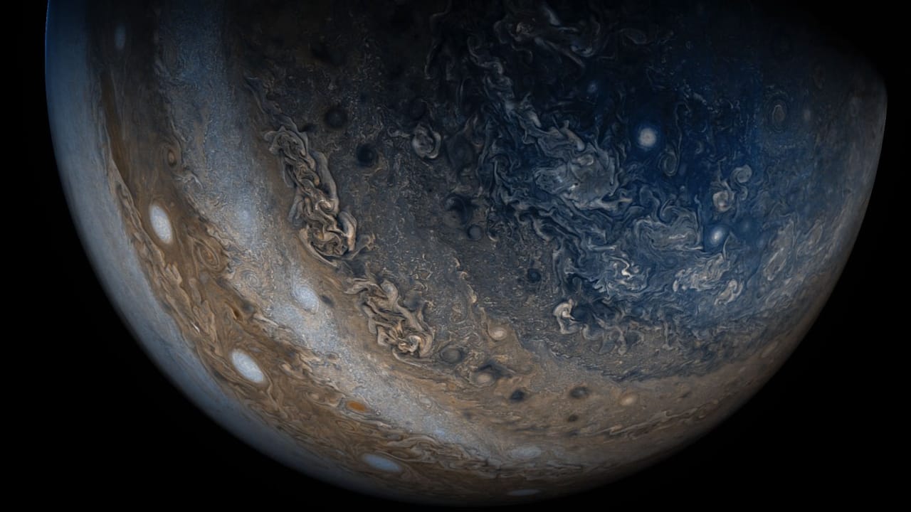 NASA Space Pictures: a view of Jupiter from below, highlighting its surface, including horizontal bands, complex patterns and swirls.