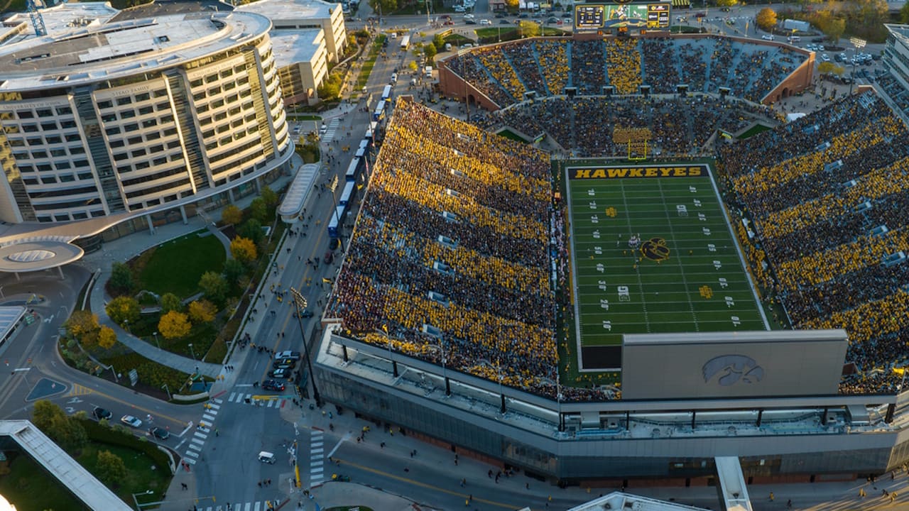 Aerial view of the University of Iowa football stadium adorned in striking yellow and black, showcasing the excitement of the game below.