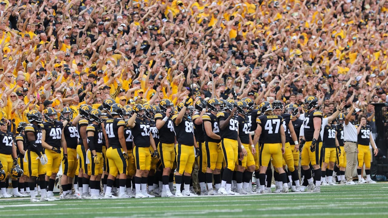 Iowa football players wave to UI Stead Family Children’s Hospital after the first quarter of a home game in unison with all the fans in the stadium.