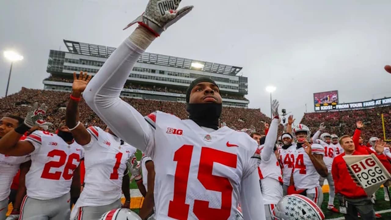 Visiting Ohio State football players wave during the Hawkeye Wave, a heartfelt tradition supporting pediatric patients.