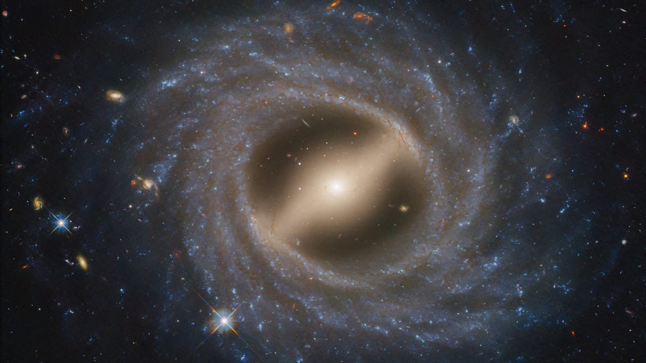 Stunning view of spiral galaxy NGC 5335, showcasing its central bar and star-forming regions, captured by Hubble Telescope.