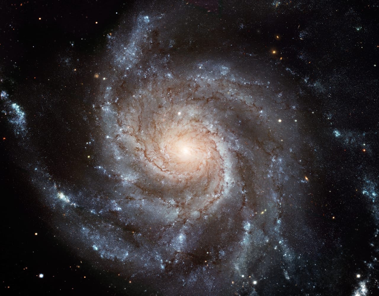 An enormous spiral galaxy with a bright core and numerous stars scattered throughout the dark background of space.