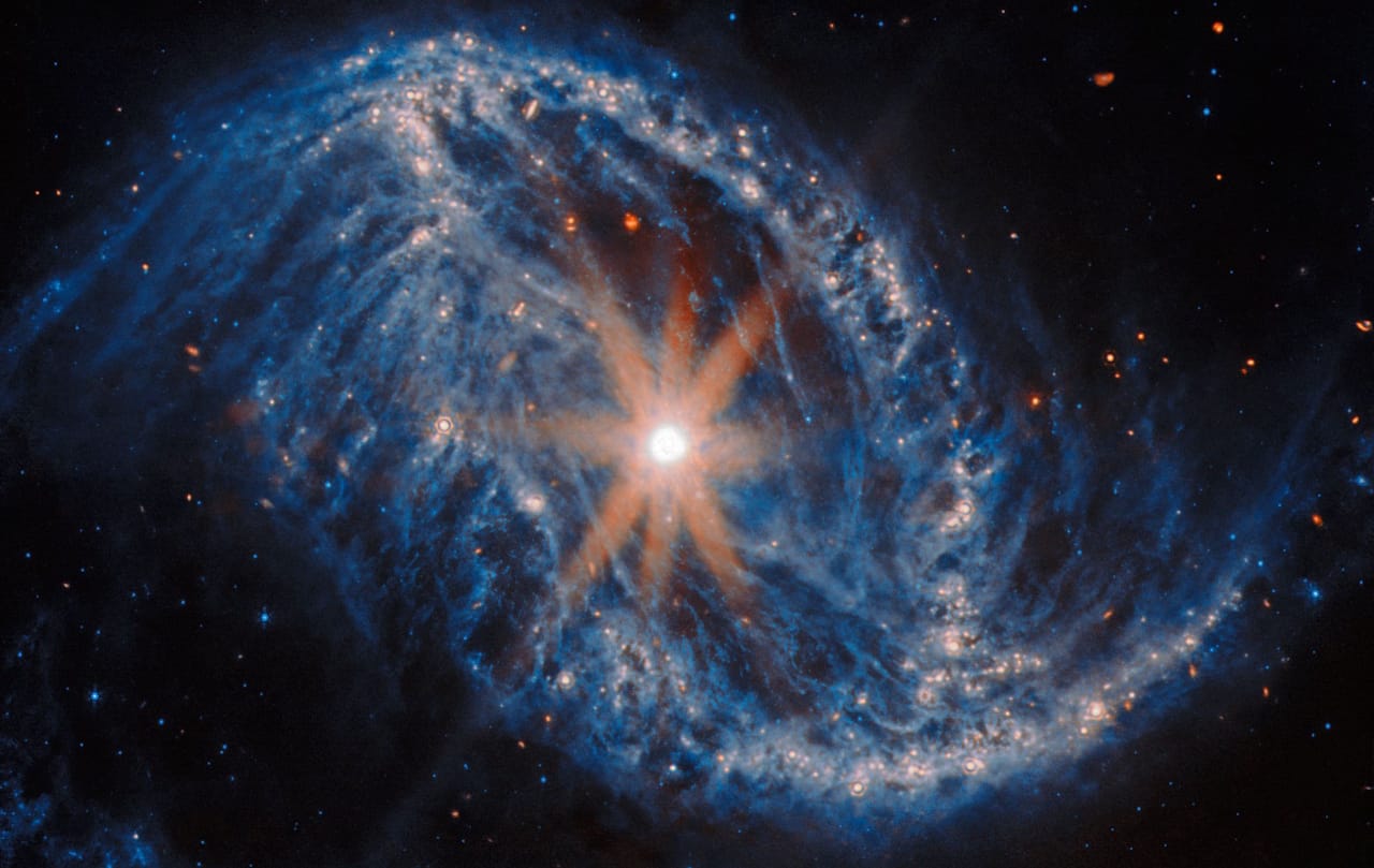 Spiral galaxy NGC 2566 in the Crab constellation, featuring bright center, spiral arms, and telescope diffraction spikes.