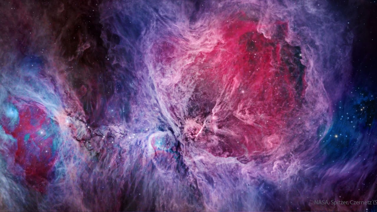 The Orion Nebula, a vibrant star-forming region, showcases colorful gas and dust, visible in the constellation Orion.