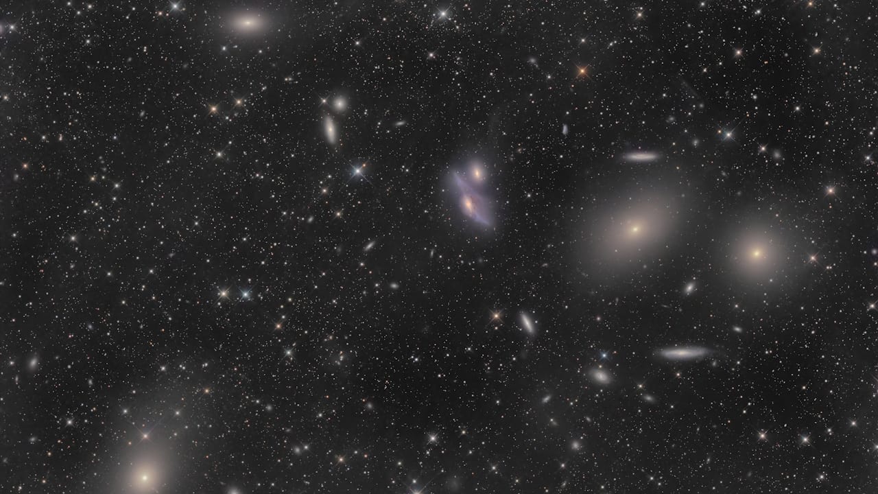 A stunning view of the Virgo Cluster, showcasing bright galaxies like M87, M86, and M84 in a cosmic tapestry of light.