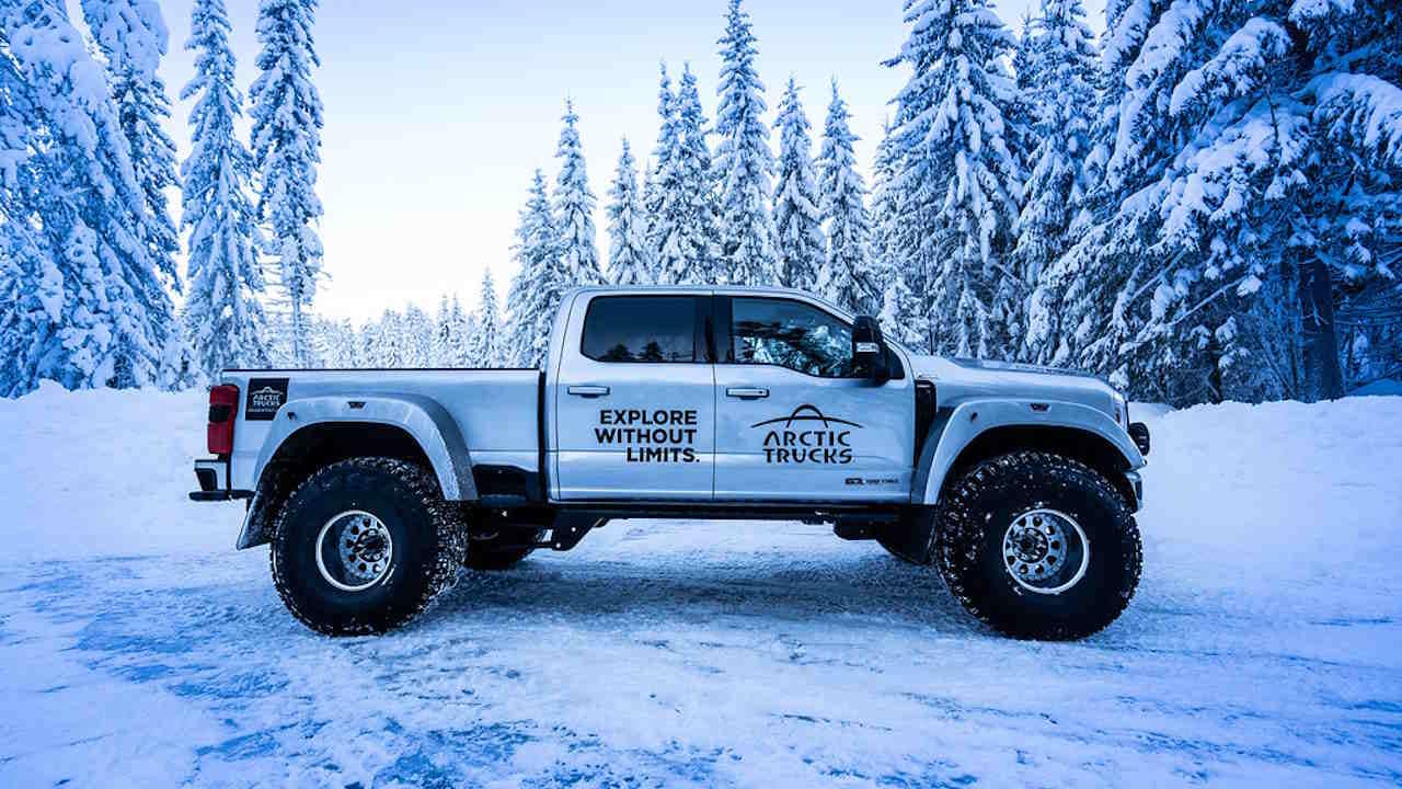 Ford F350 heavily modified crew cab with dually rear fenders on 44 inch tires.