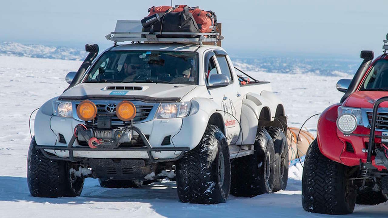 White Toyota 6x6 pulling a sled with gear during the 2018 Greenland expedition.