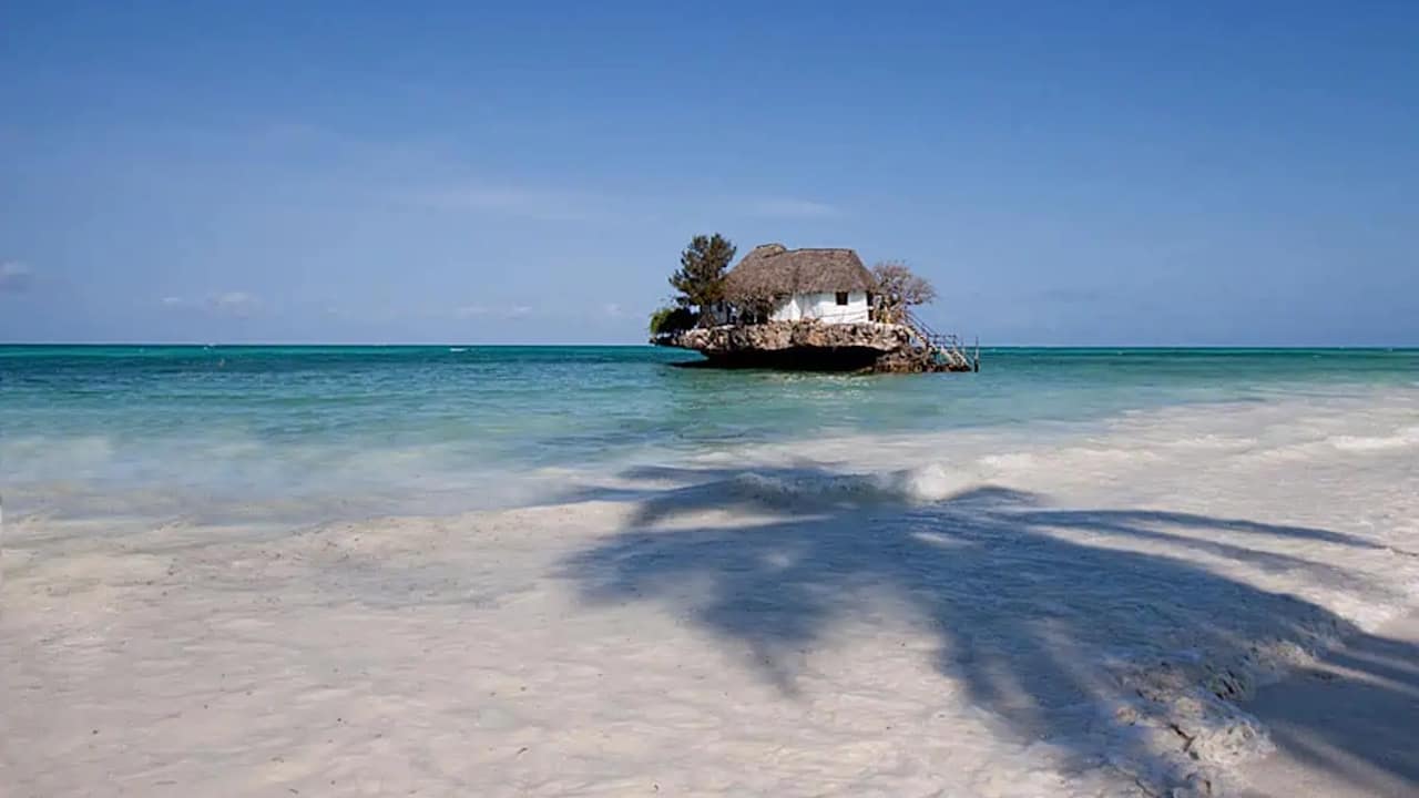 The Rock Restaurant on its tiny island just off the beach of the island of Zanzibar.