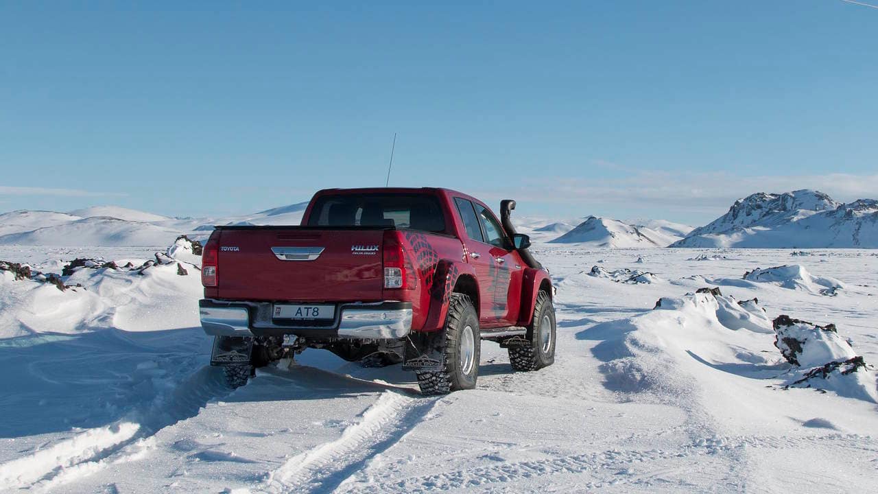 Arctic Trucks AT8 red arctic expedition 4x4 truck shown in the Arctic.