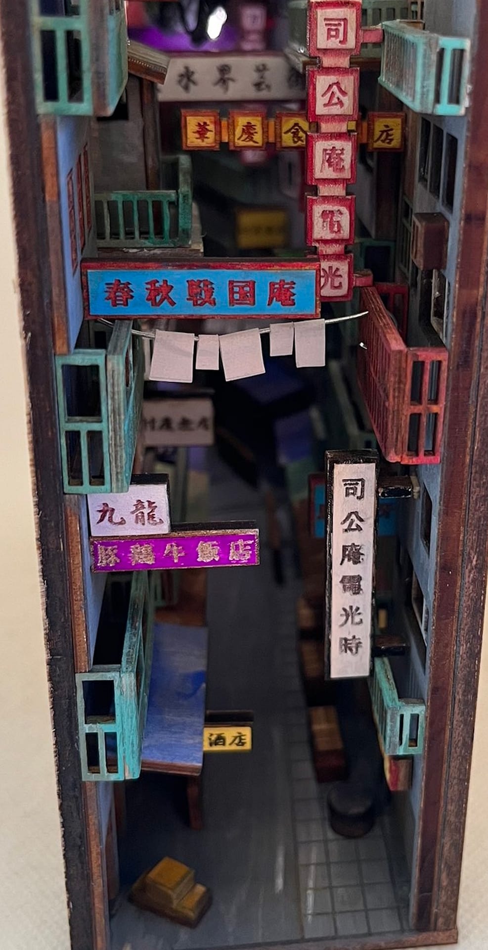 Image of a narrow allow book nook with commercial space on the first floor and apartments on the floors above.